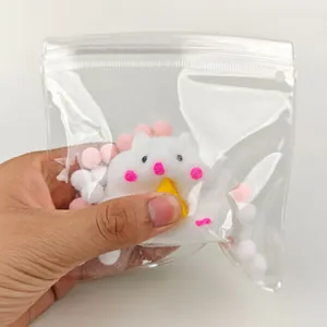 Detail shot of white plush hamster squishy toy in clear packaging for stress relief