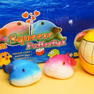 Close-up of blue and pink pufferfish squishy toys with colorful packaging