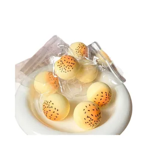 Detail showing slow-rebound squishy yolk pastry toys on a white ceramic plate.