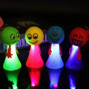 Jouets de saut à ressort LED colorés avec visages d'émoticônes amusants pour enfants