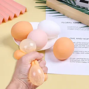 Detailed view of an egg stress toy being squeezed, revealing a sparkling glitter gel center