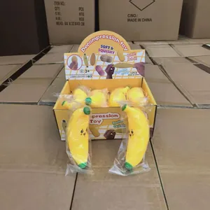 Jouets à presser en forme de banane jaune avec expressions dans une boîte de vente