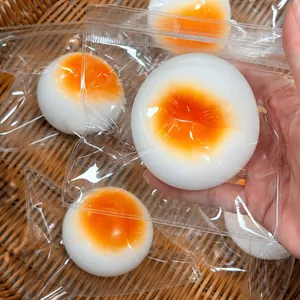 Close-up view of a simulation steamed bun squishy toy with slow rebound texture held in hand