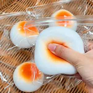 Detail of a soft squishy bun toy being squeezed, showing its liquid filling texture