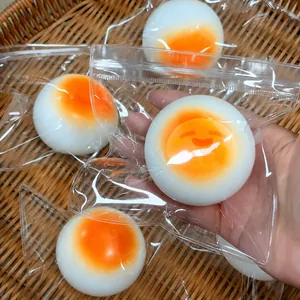Close-up detail showing simulation poached egg decompression toy in its PVC packaging
