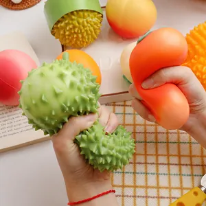 Detailed macro shot of hands squeezing a realistic green durian stress relief squishy toy