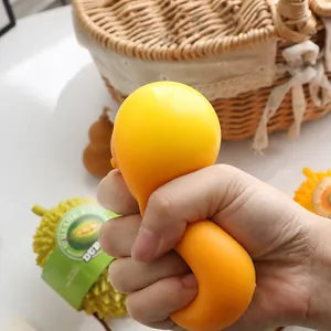 Close-up of hand squeezing yellow soft stress relief toy in a creative durian shape