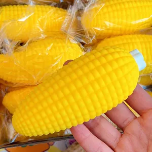 A close-up detail of realistic yellow corn squishy stress relief toy held in hand