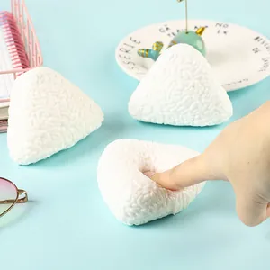 Close-up of slow rebound rice ball squishy toy being pressed for stress relief.