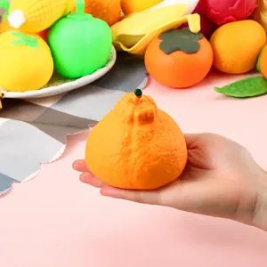 Orange fruit squeeze toy detail showing textured surface and hand-held size