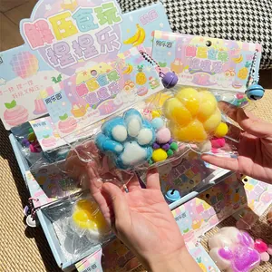Macro view of colorful plush cat paw squishy toys in retail packaging with bells