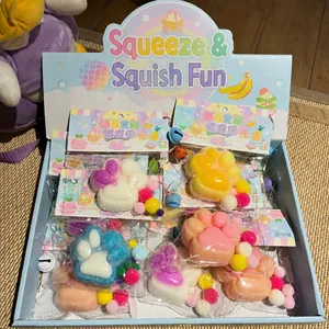 Detailed macro view of colorful plush cat paw squishy toys in their retail display box