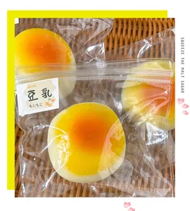 Close-up detail of a realistic soy milk bun squeeze toy in a clear zipper bag for stress relief