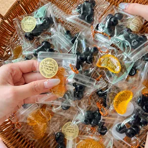 Close-up of mini simulation fruit squishy toys in individual zip bags with labels