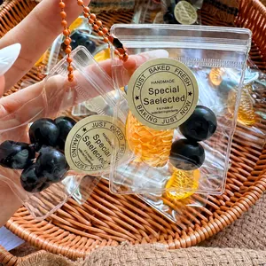 Detailed view of mini fruit squeeze toy bags with blueberries and orange slices inside.