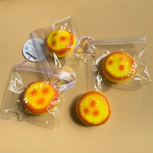 Realistic egg tart slow-rebound squeeze toy for stress relief in plastic packaging.