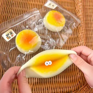 Soft TPR soy milk bun squeezy stress relief toy shown being squeezed and in packaging