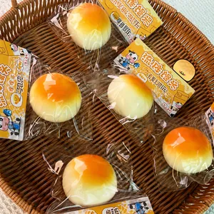 Macro view of realistic milk bun squishy stress relief toys in individual clear packaging