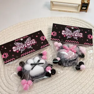 Soft plush cat paw squishy toys in pink and black color schemes for stress relief