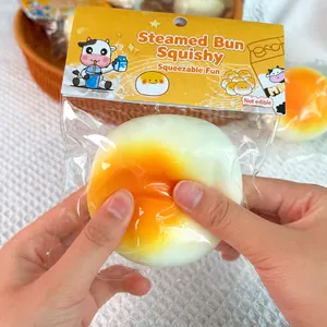 Detail view of slow rebound milk bun squishy toy being squeezed to show creamy texture