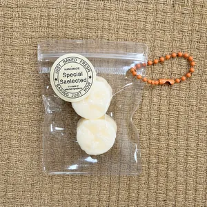Close-up of mini fruit citrus squishy toy in a clear zipper bag with an orange chain