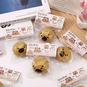 Multiple brown Capybara squishy decompression toys in original packaging on a wooden desk.