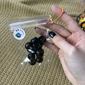 Detailed close-up of realistic simulation blueberry squishy toy in a clear plastic bag.