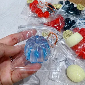 Detailed view of a transparent blue Canelé-shaped squishy toy in a bag for stress relief.