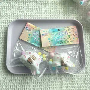 Cute flocked hamster squishy toys in colorful packaging on a purple tray backdrop