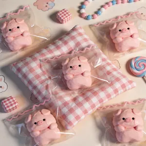 Detailed view of pink pig silicone squeeze toys in individual packaging