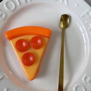 Detailed slow-rebound pizza slice squishy toy on a white ceramic plate for stress relief