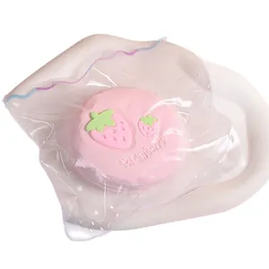 Pink strawberry souffle silicone squishy toy in clear packaging for stress relief