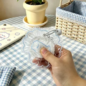 Close-up view of a ruffled transparent fish-shaped silicone squeeze toy held in hand