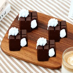 Detailed close-up of realistic chocolate-shaped silicone squishy toys with white cream filling
