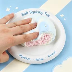 Detailed macro view of a soft squishy bun toy being squeezed to show slow rebound