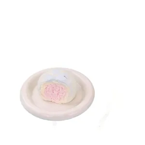 Soft food-grade silicone bitten bun squishy toy for stress relief, displayed on a beige plate