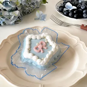 Close-up detail of a blue star-shaped cake squishy toy with pink bow decoration