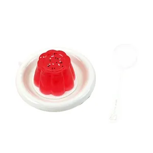 Food-grade silicone watermelon pudding squishy toy on white plate with spoon for stress relief