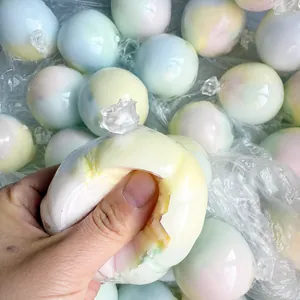Close-up of handmade crispy skin squishy ball showing cracking texture when squeezed