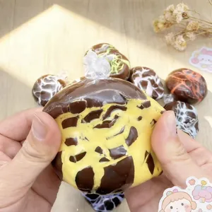 Squeezing a chocolate patterned squishy decompression ball toy for stress relief