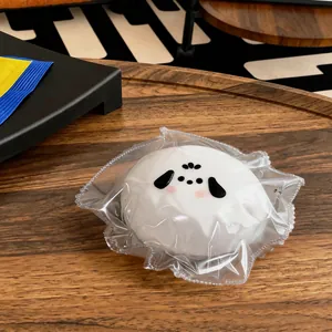 Close-up of a cute dog-shaped bun squishy toy made of white food-grade silicone.