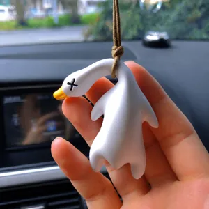 Close-up detail of a creative UV color-changing duck car rear-view mirror hanging ornament