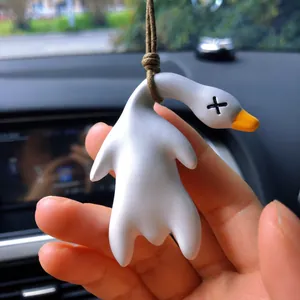 Detailed view of a creative UV-sensitive duck car pendant hanging in a vehicle interior.