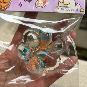 Detail showing texture of starry cat paw squishy toy with colorful sequins inside