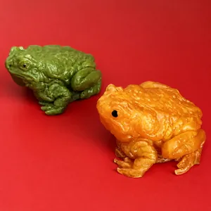 Realistic toad squishy stress relief toy in green and orange colors with bumpy texture