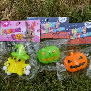 Close-up of Halloween ghost and pumpkin squeeze toys in individual retail packaging