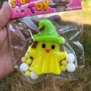 Cute Halloween ghost squeeze toy with green wizard hat inside plastic gift packaging
