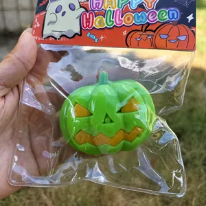 Detail view of green Halloween pumpkin squishy stress relief toy in original packaging.