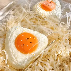 Close-up of handmade silicone egg yolk rice ball squishy toy in gift box packaging