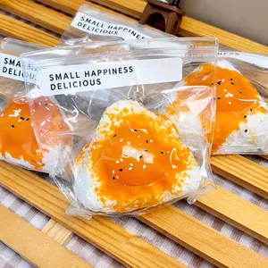 Close-up of creative egg yolk onigiri squishy stress relief toys in different sizes